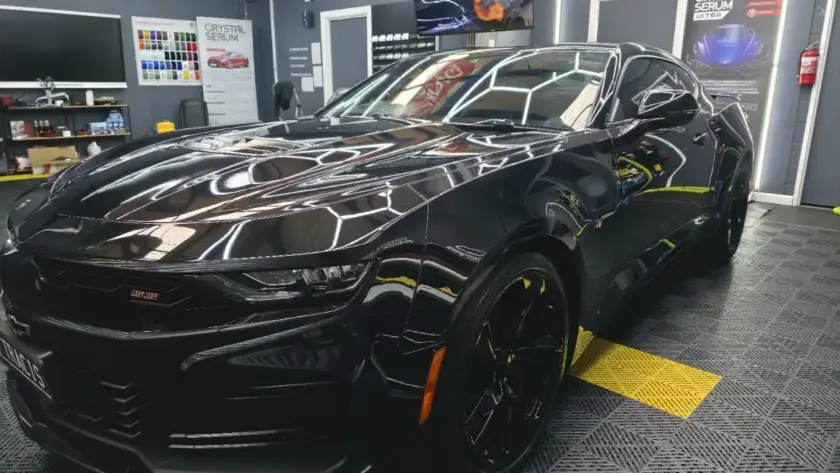 Vehicle being washed, showcasing hydrophobic properties of 5-year ceramic coating
