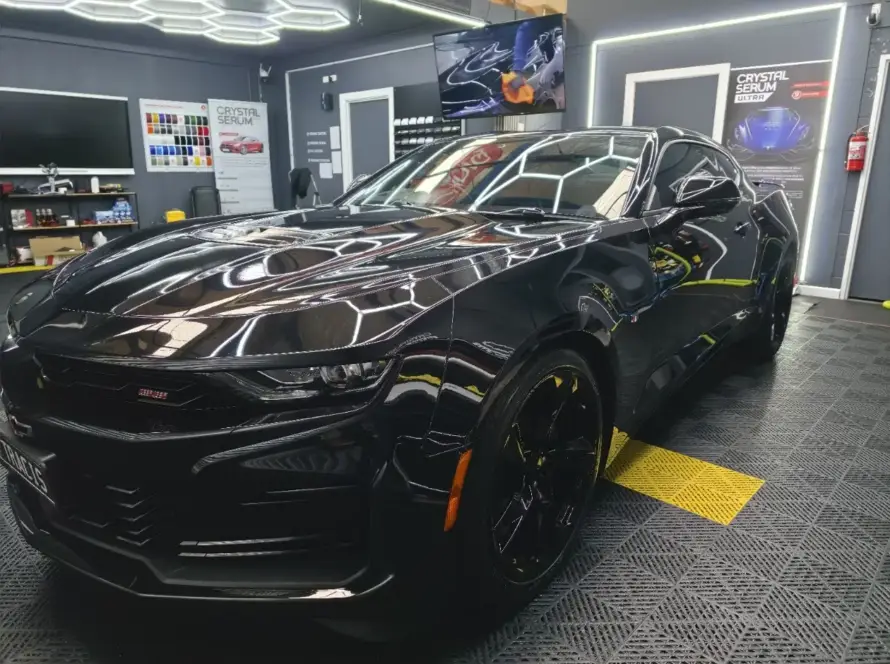 Vehicle being washed, showcasing hydrophobic properties of 5-year ceramic coating
