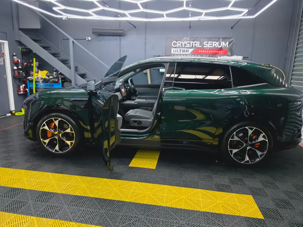 Green performance SUV with paint protection film, doors open, in our Keysborough workshop