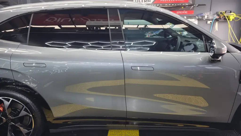 Close-up of clear paint protection film on a grey car door, Keysborough